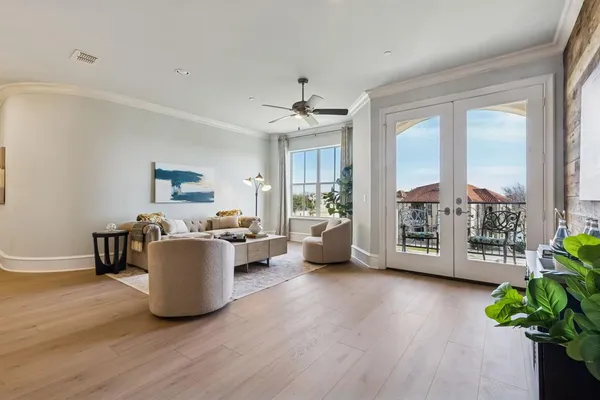 a living room with furniture and a potted plant