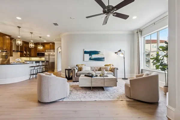 a living room with furniture and kitchen view