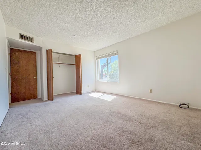 a kitchen with granite countertop a refrigerator and a sink