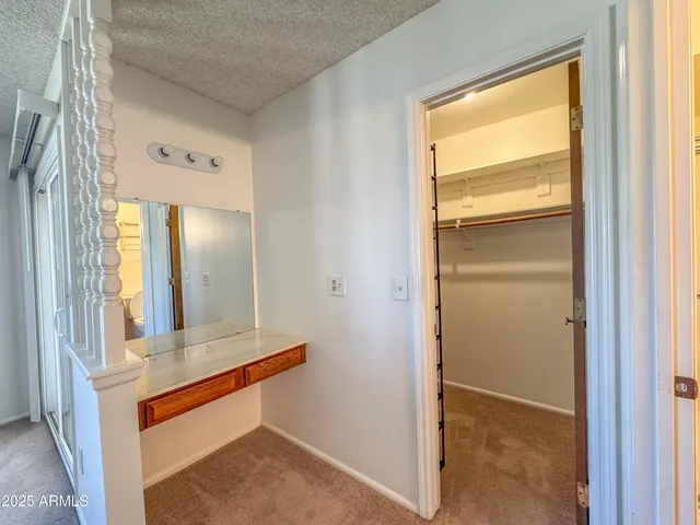an empty room with windows and ceiling fan