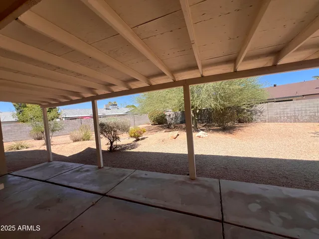 an empty room with windows and fireplace