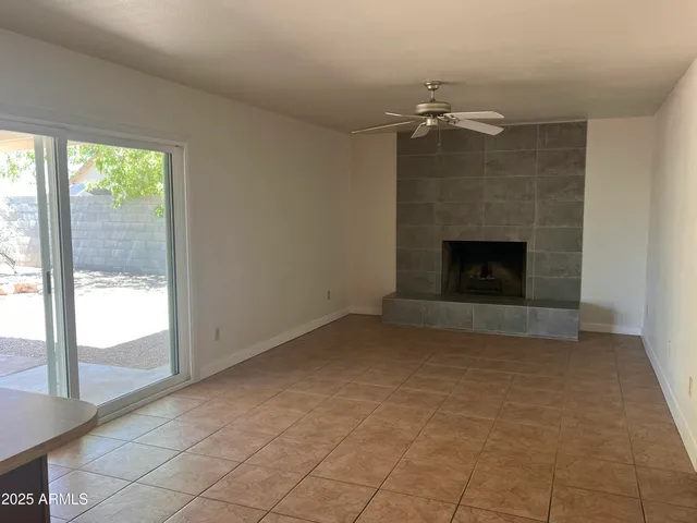 a view of a livingroom with wooden floor and staircase