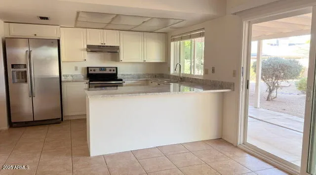 a view of an empty room with a fireplace and a window