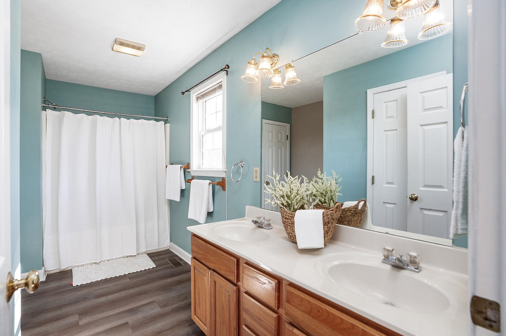 812 New Hope Road Staunton, VA 24401 - Photo 26 of 67 a bathroom with a granite countertop sink a mirror and a potted plant