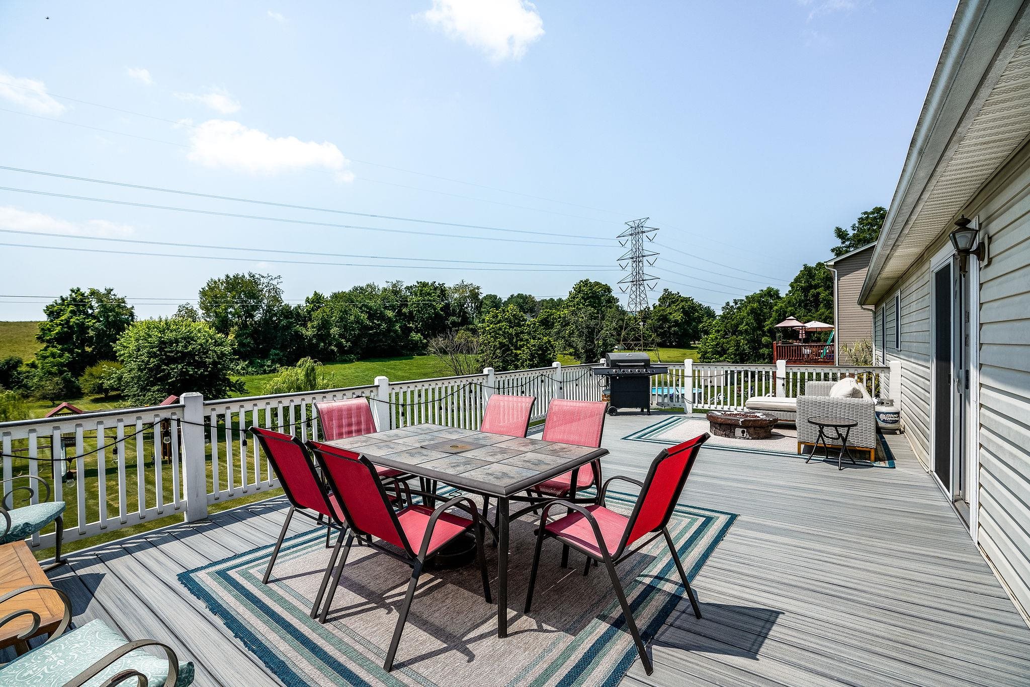 812 New Hope Road Staunton, VA 24401 - Photo 51 of 67 a view of a roof deck with table and chairs a barbeque with wooden floor and fence