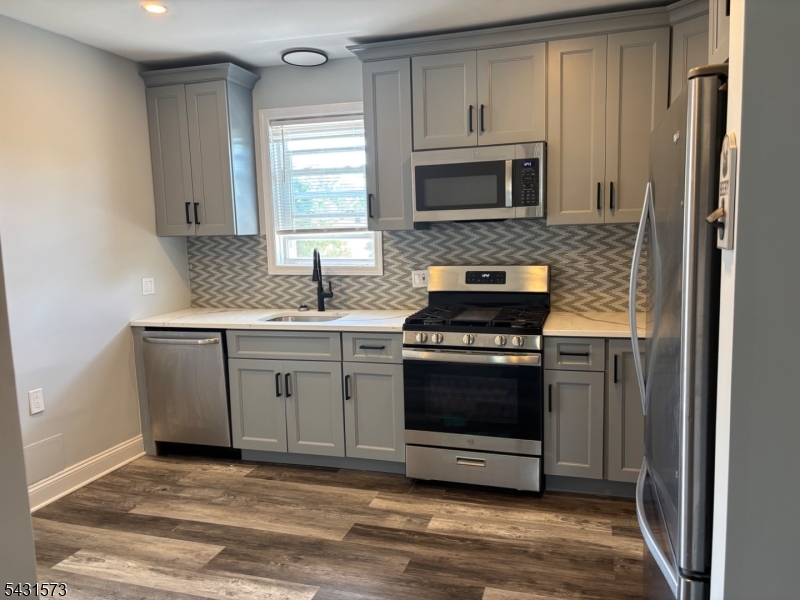 358 Woodland Road, Unit 2 Madison, NJ 07940 - Photo 8 of 50 a kitchen with granite countertop a stove and a microwave