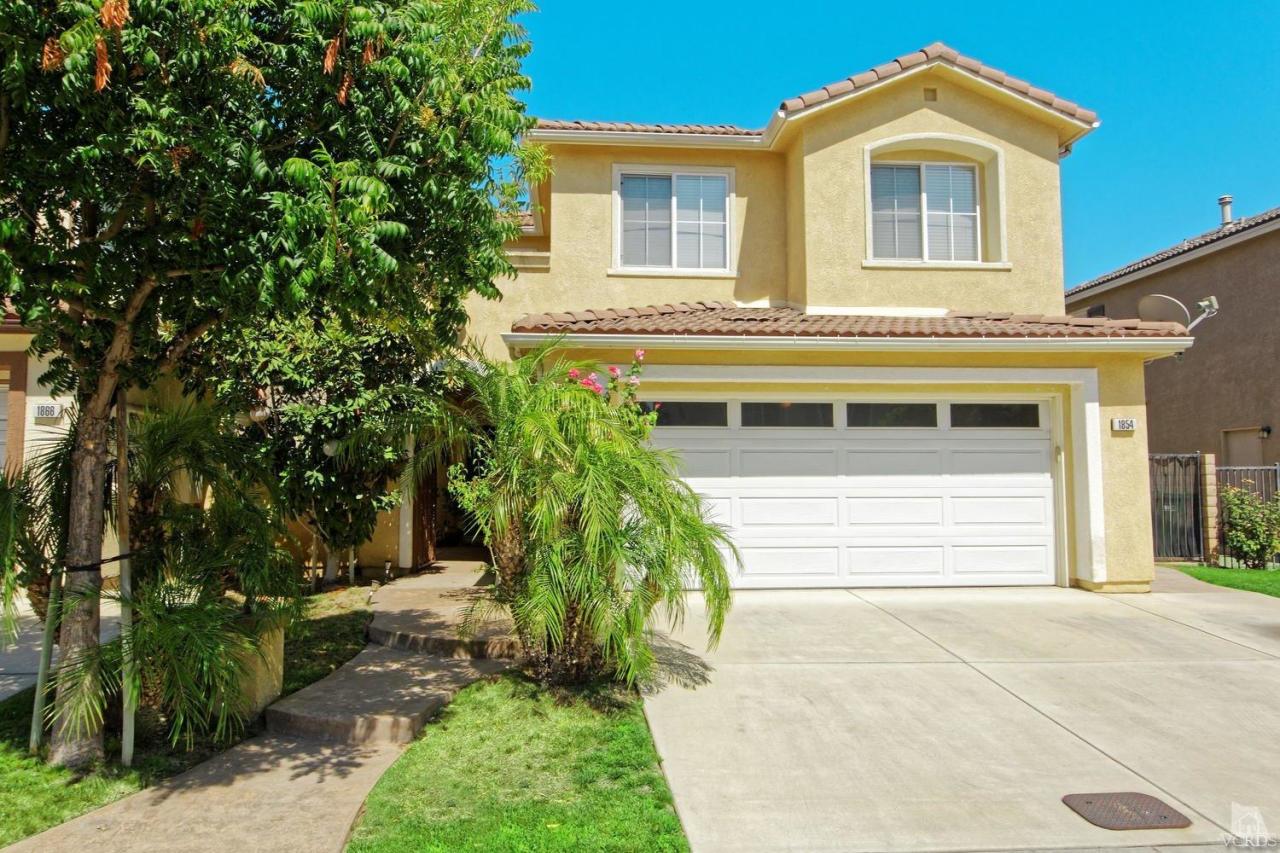 1854 Locust Street Simi Valley, CA 93063 - Photo 2 of 17 a front view of a house with a yard and trees