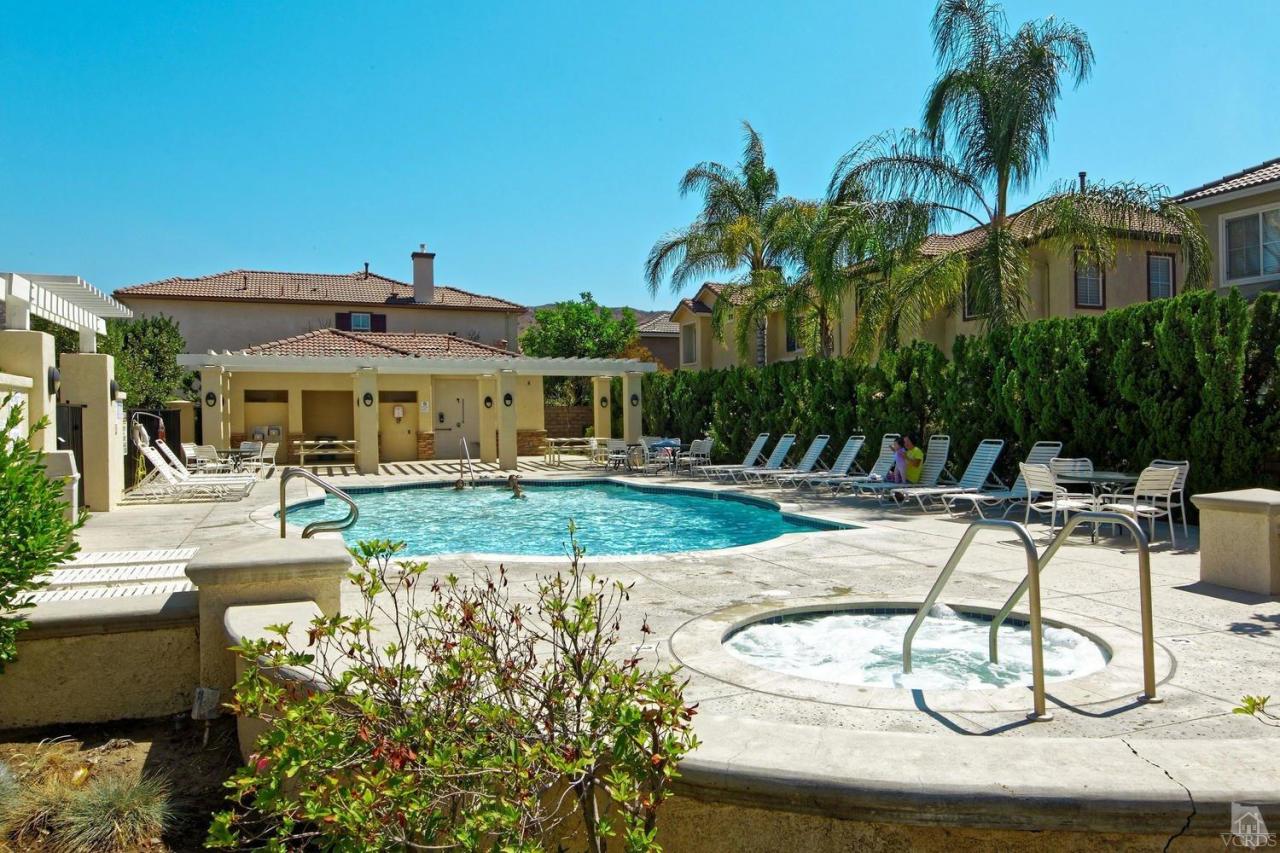 1854 Locust Street Simi Valley, CA 93063 - Photo 15 of 17 a patio with a table and chairs under an umbrella