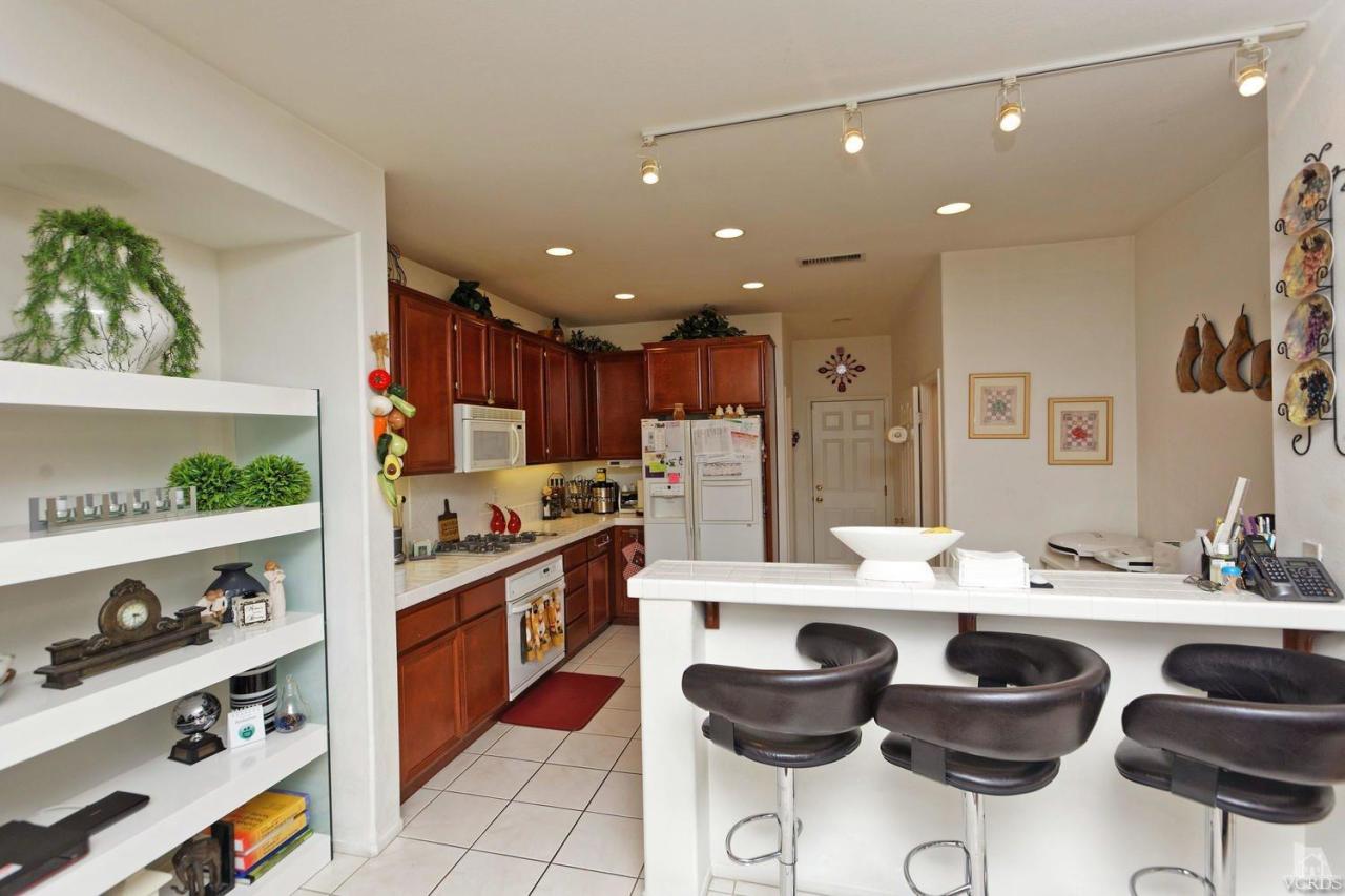 1854 Locust Street Simi Valley, CA 93063 - Photo 10 of 17 a kitchen with stainless steel appliances kitchen island granite countertop a sink and cabinets
