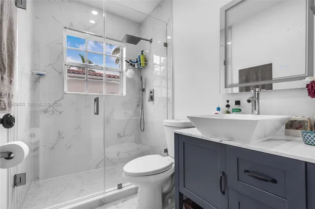 a bathroom with a sink toilet and shower