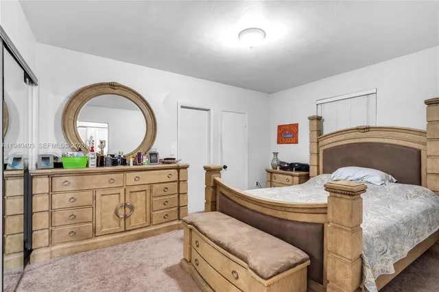 a bedroom with a bed and a dresser