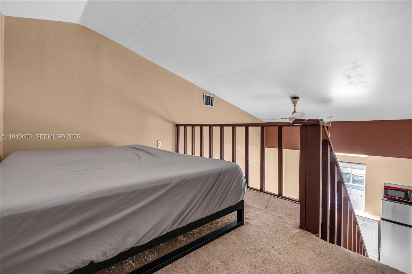 2145 Southwest 26th Street Miami, FL 33133 - Photo 17 of 26 a bed sitting in a bedroom next to a window