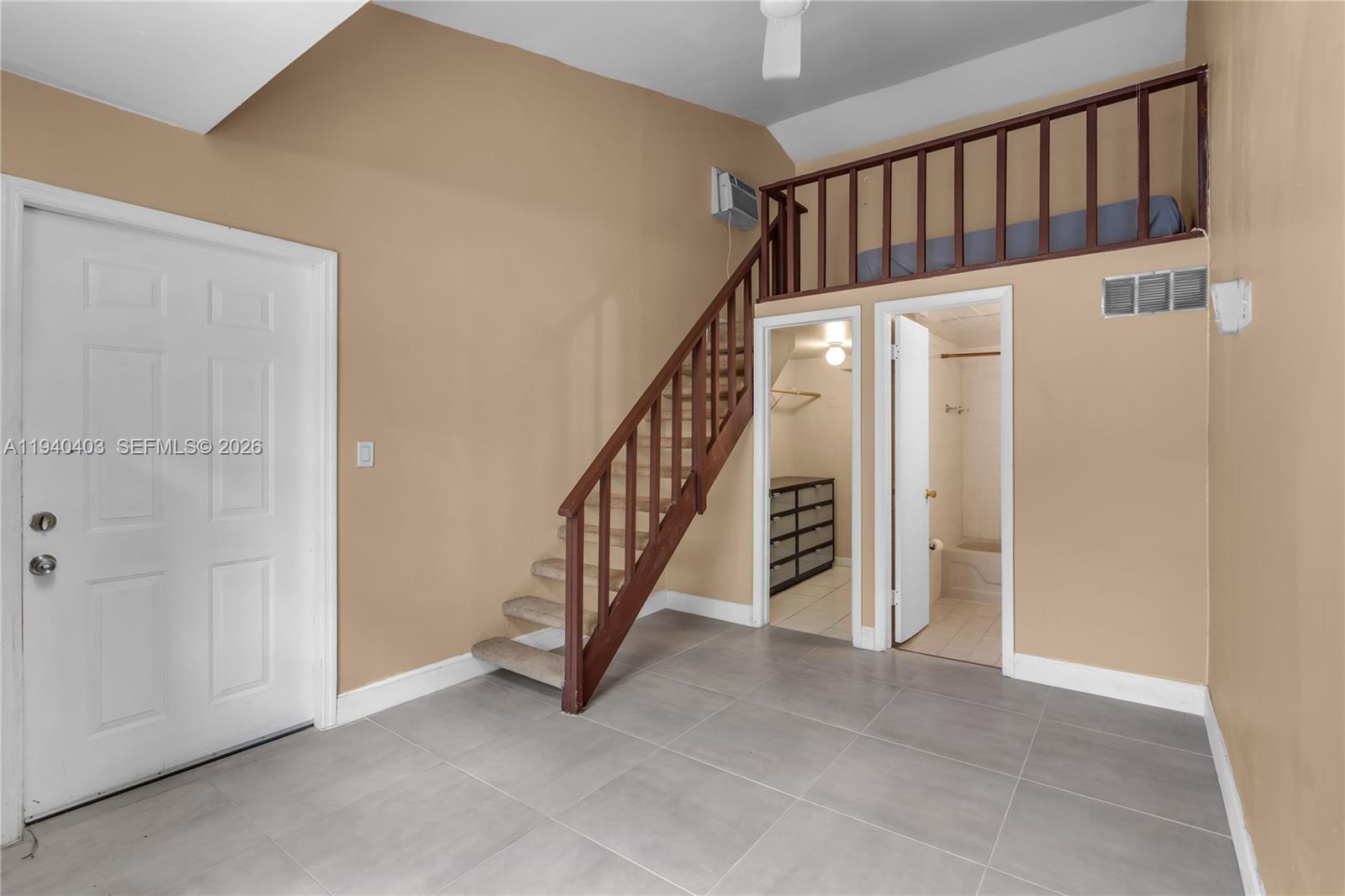 2145 Southwest 26th Street Miami, FL 33133 - Photo 3 of 26 a view of staircase with white walls and a window