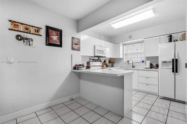 a kitchen with cabinets and window