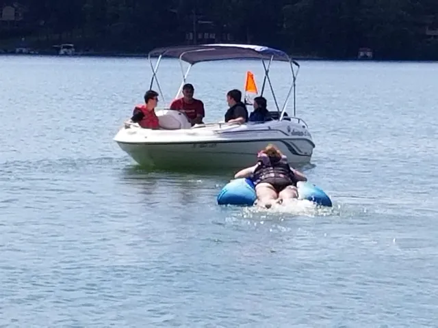 a group of people sitting on bed in a room
