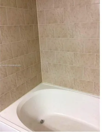 a bathroom with a granite countertop toilet and a sink
