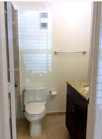 a bathroom with a granite countertop sink a mirror and a shower