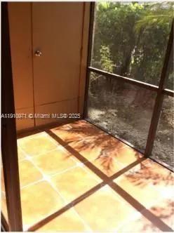 a view of a balcony with a yard