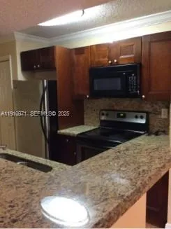 a kitchen with a refrigerator and a microwave