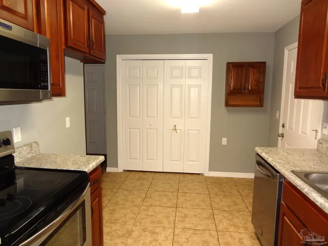 a kitchen with a sink stove and microwave