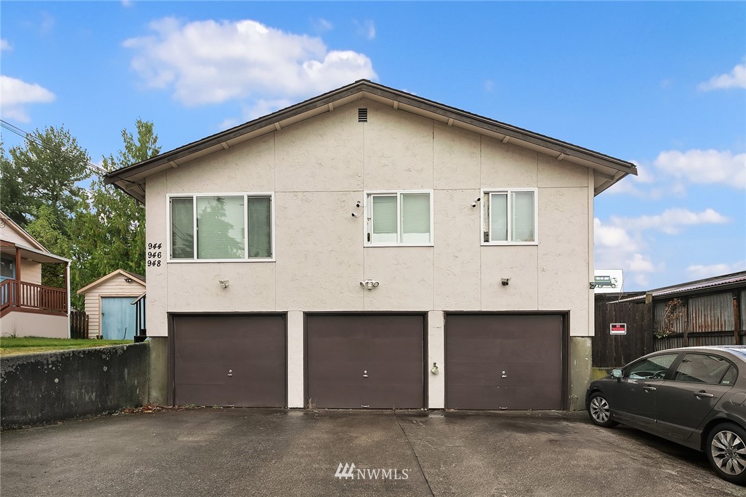946 North 89th Street Seattle, WA 98103 - Photo 2 of 16 a front view of a house with parking space