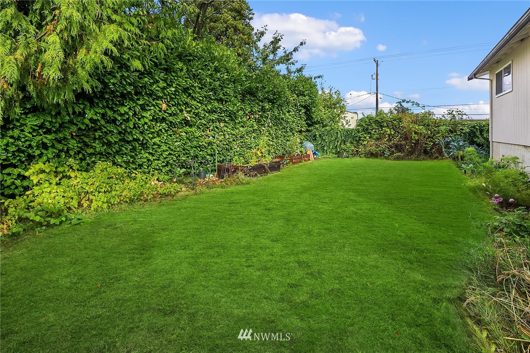 946 North 89th Street Seattle, WA 98103 - Photo 13 of 16 a view of a field of grass and trees