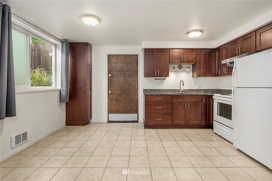 946 North 89th Street Seattle, WA 98103 - Photo 4 of 16 a kitchen with a stove a refrigerator and a sink
