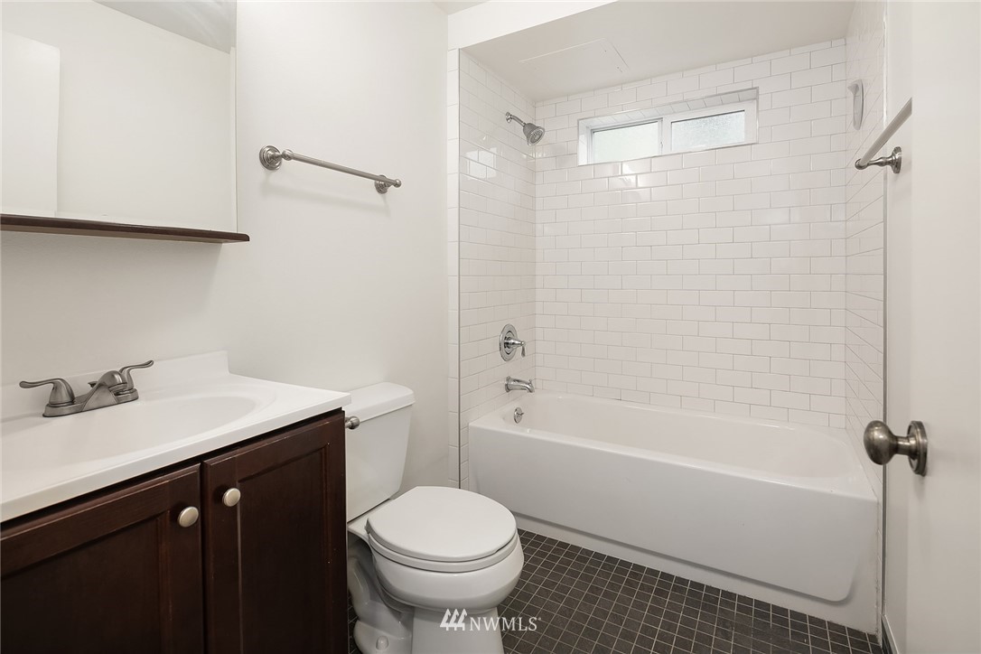 946 North 89th Street Seattle, WA 98103 - Photo 6 of 16 a bathroom with a sink a toilet and shower