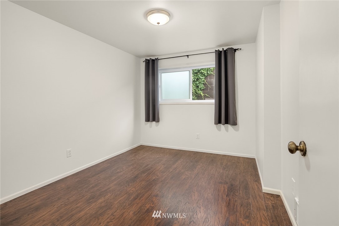 946 North 89th Street Seattle, WA 98103 - Photo 7 of 16 an empty room with wooden floor and windows