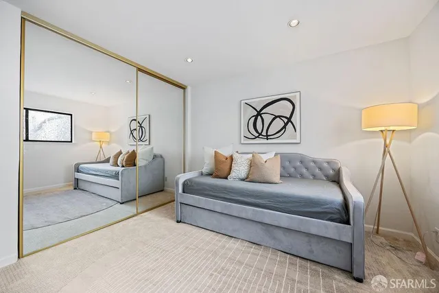 a bedroom with a bed and a couch