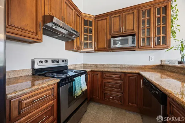 a kitchen with stainless steel appliances granite countertop a stove and a sink