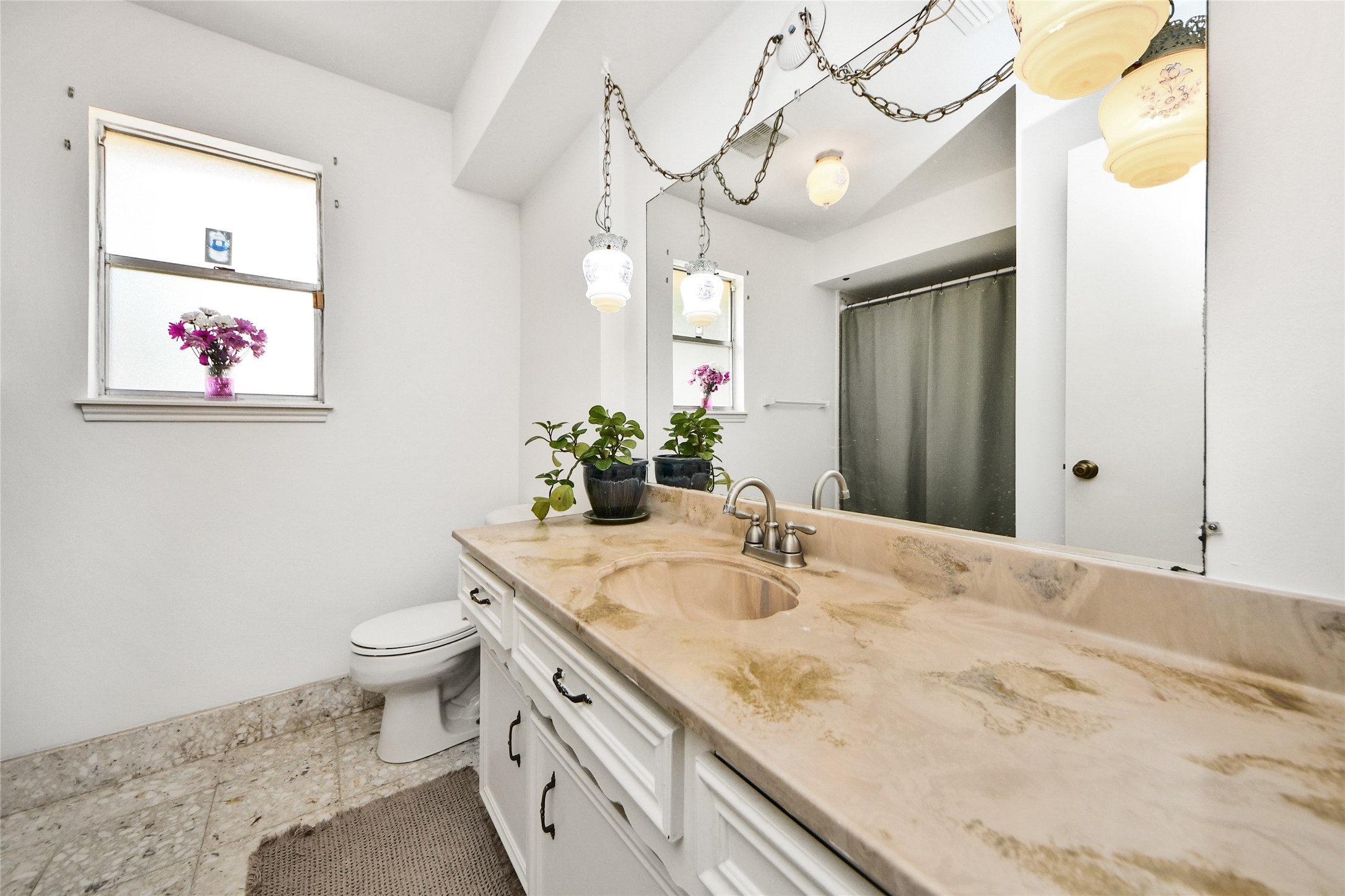 3030 Bernadette Lane Houston, TX 77043 - Photo 16 of 31 a bathroom with a granite countertop sink a toilet and a mirror