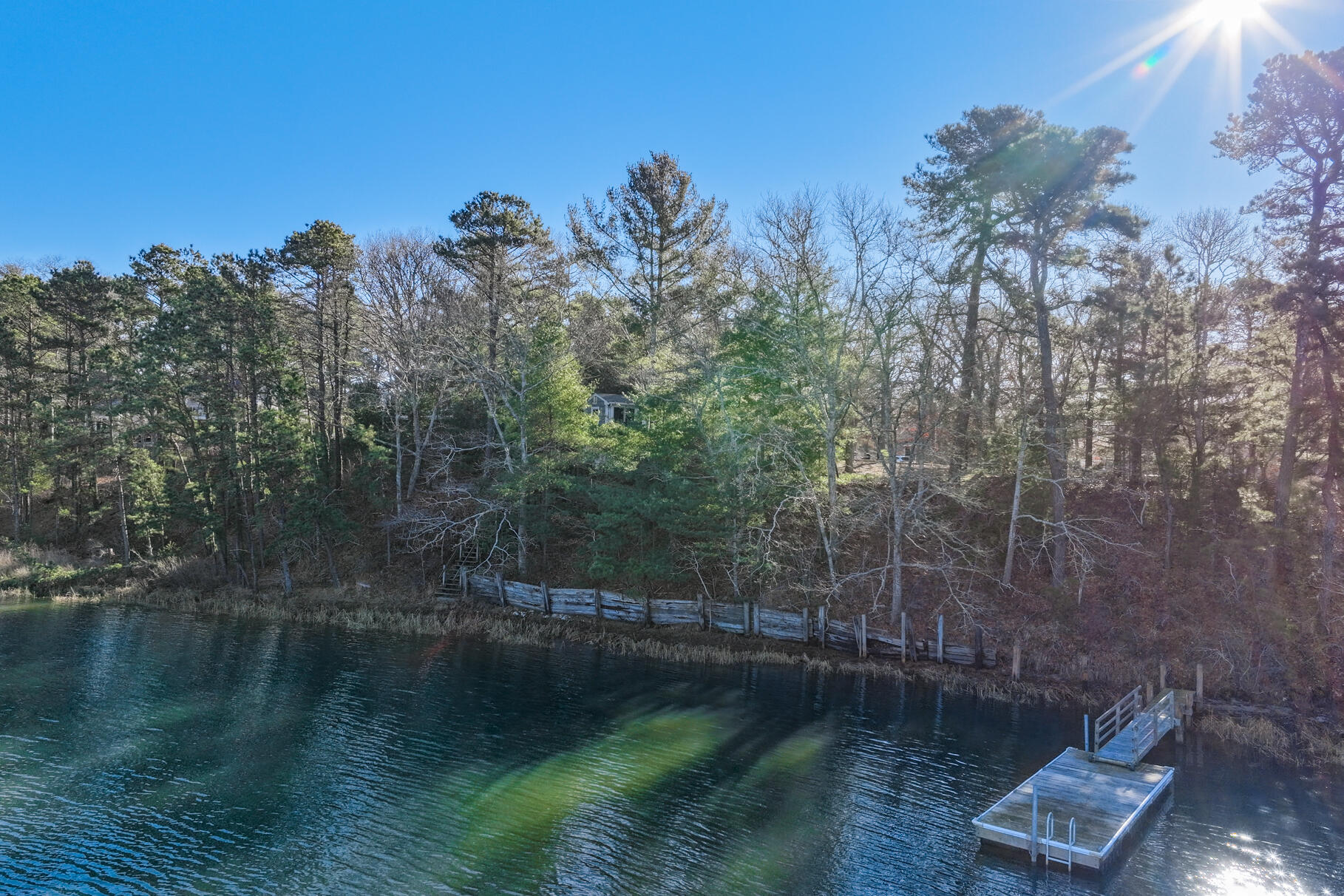 71 Buccaneer Way Mashpee, MA 02649 - Photo 19 of 32 a view of a lake with trees all around