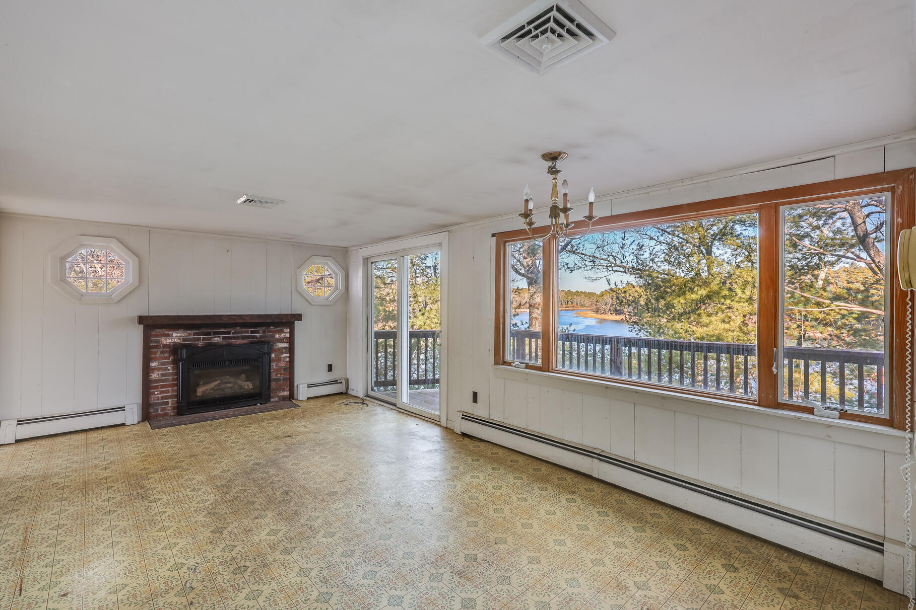 71 Buccaneer Way Mashpee, MA 02649 - Photo 6 of 32 wooden floor fireplace and windows in an empty room