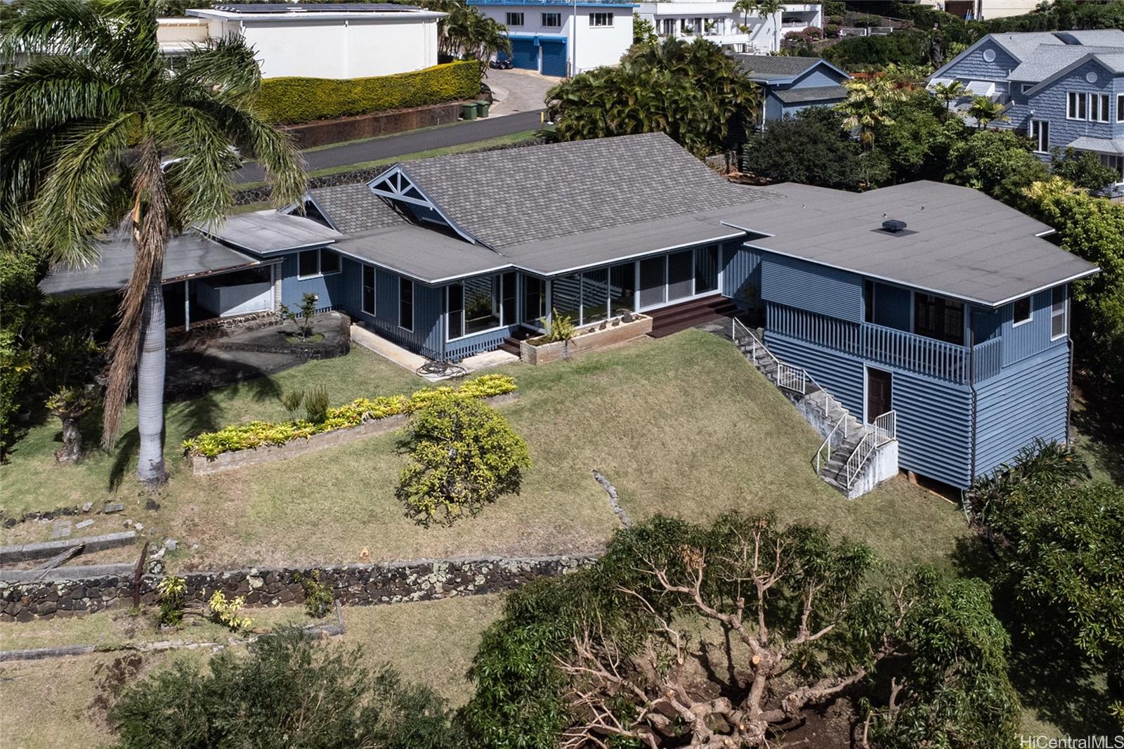 an aerial view of a house with a yard basket ball court and outdoor seating