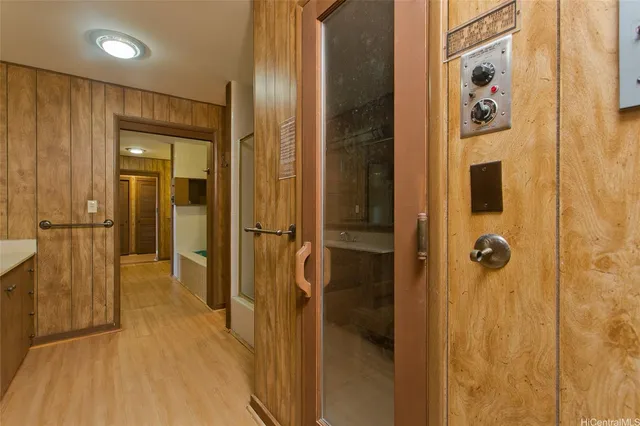 a view of a hallway with wooden floor