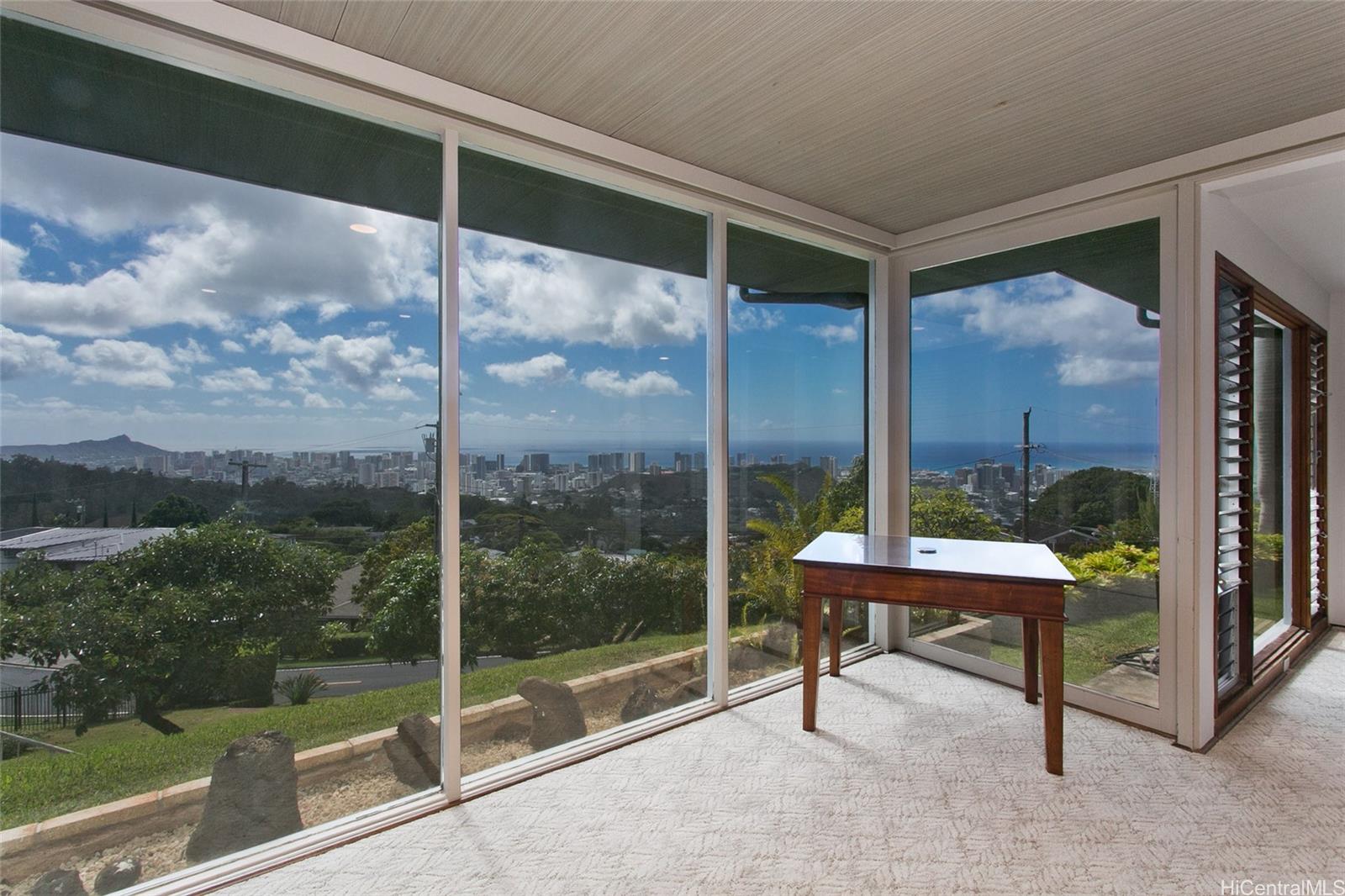 3233 Pacific Heights Road Honolulu, HI 96813 - Photo 3 of 25 a view of a porch with chairs and floor to ceiling window