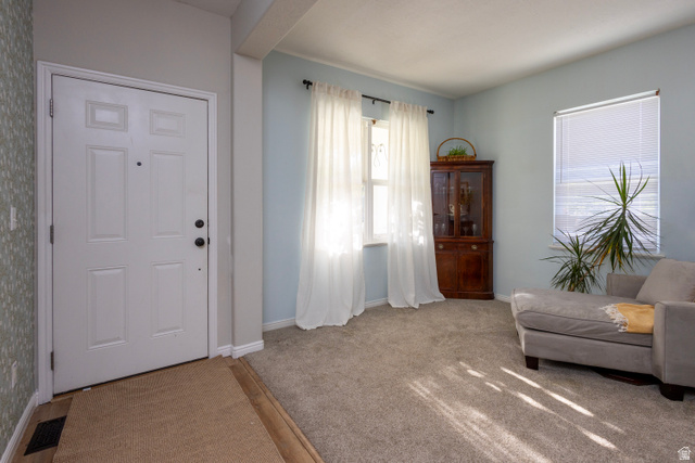 11751 Lake Run Road South Jordan, UT 84009 - Photo 4 of 38 Inviting entry area with a six-panel door, wood-finish flooring, and light-toned carpet