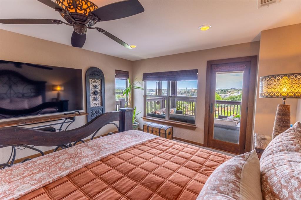 7060 Hells Gate Loop Strawn, TX 76475 - Photo 15 of 40 a bedroom with a bed dresser and a flat tv screen