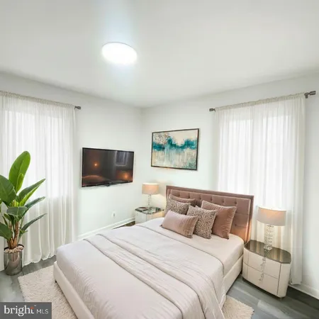 a bedroom with a bed and a flat screen tv