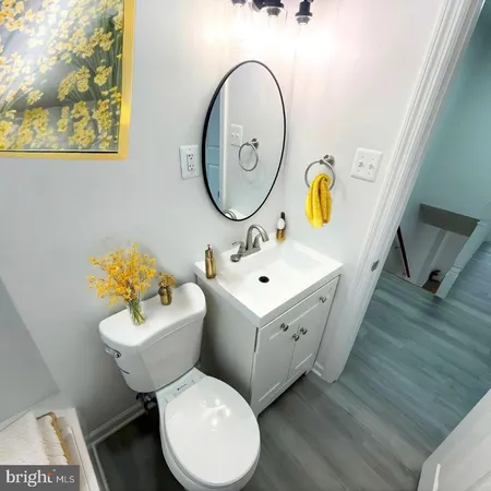 a bathroom with a toilet sink and mirror