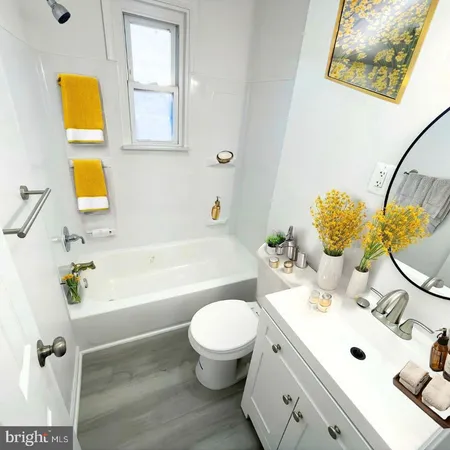 a bathroom with a sink mirror toilet and bathtub