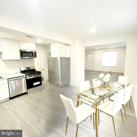 a kitchen with stainless steel appliances kitchen island granite countertop a sink and cabinets