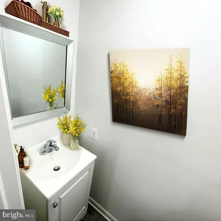 a bathroom with a sink a mirror and a window