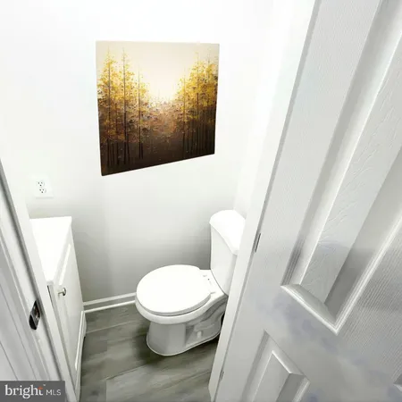 a white toilet sitting next to a small sink