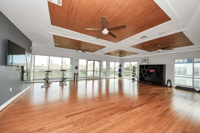 a living room with furniture flat screen tv and window