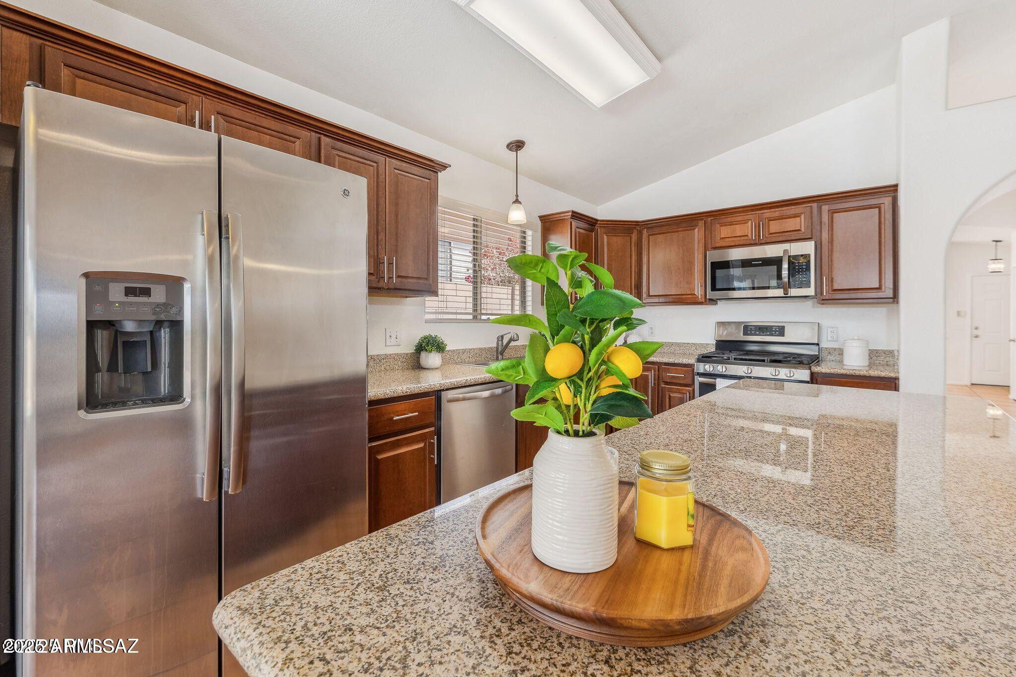 11161 North Par Drive Oro Valley, AZ 85737 - Photo 11 of 35 a kitchen with a refrigerator and a stove