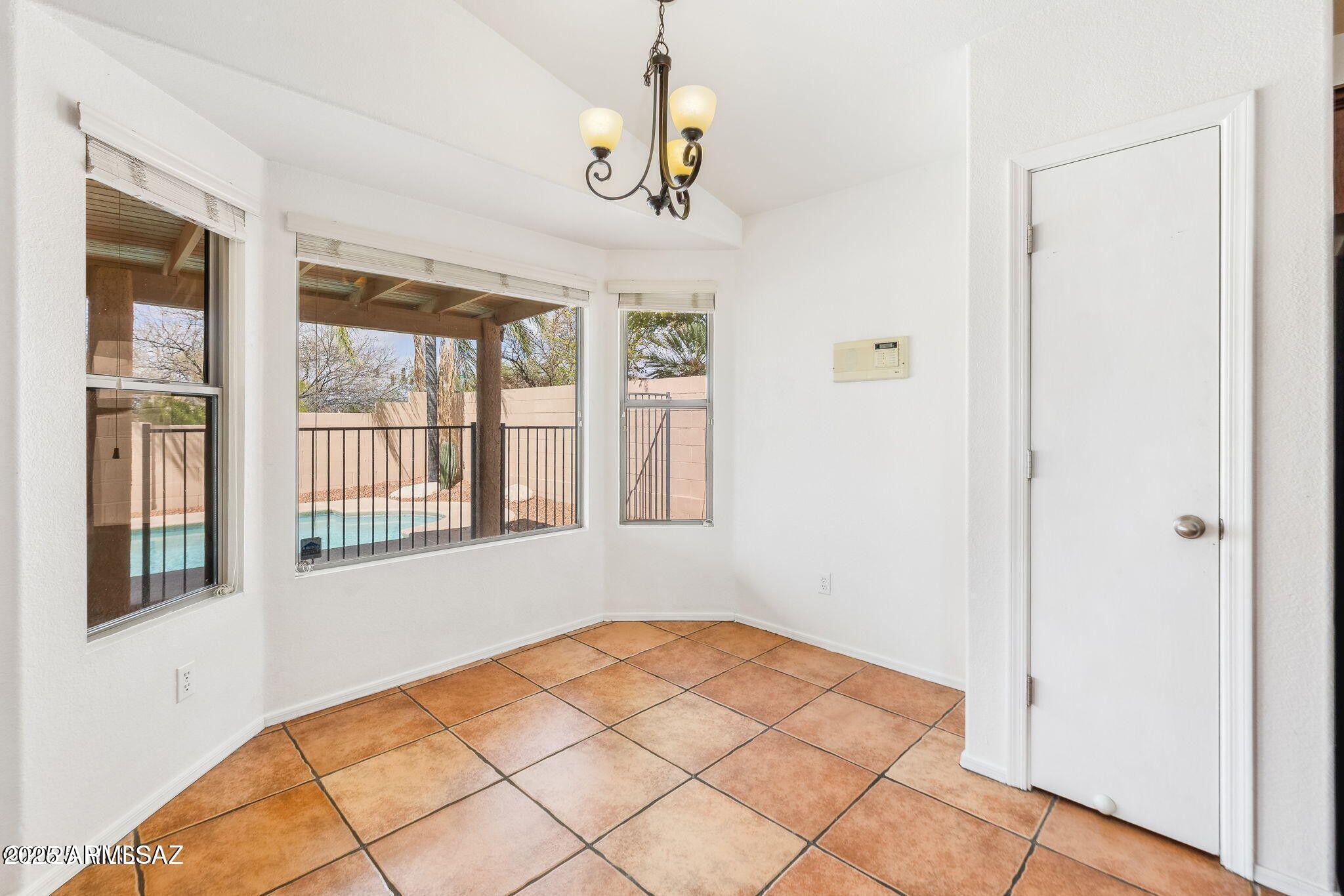 11161 North Par Drive Oro Valley, AZ 85737 - Photo 12 of 35 a bedroom with a bed and a large window