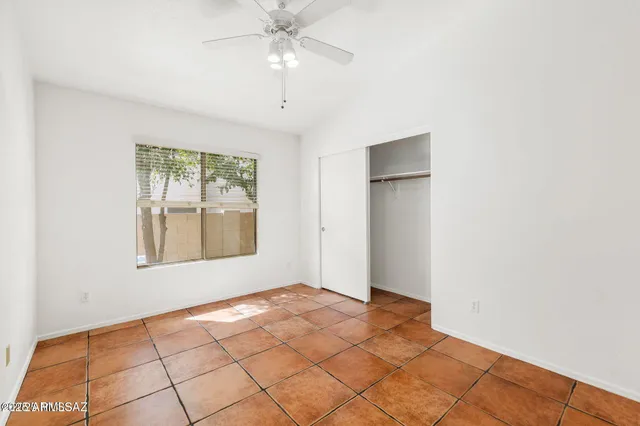 a view of a room with a ceiling fan