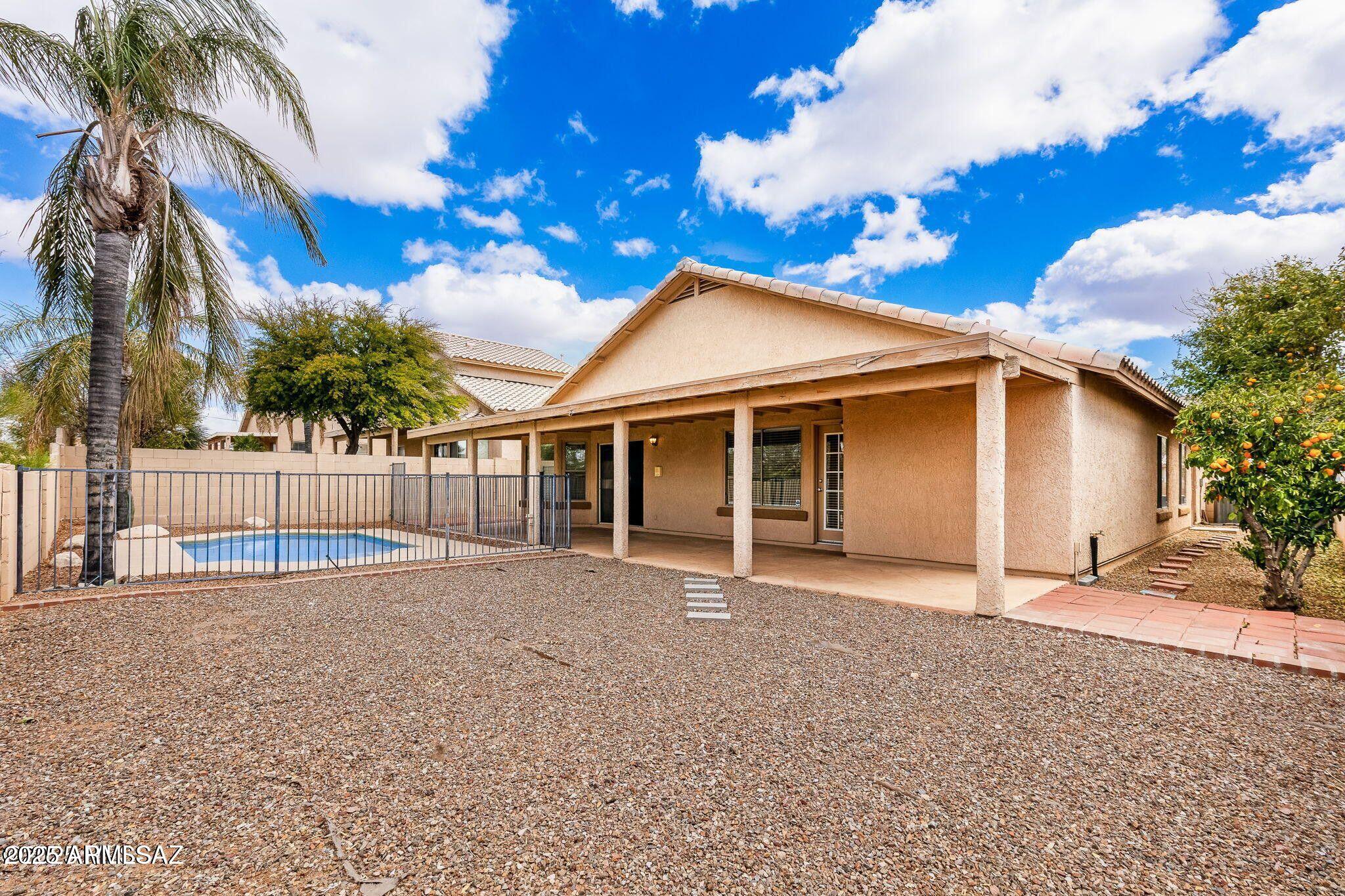 11161 North Par Drive Oro Valley, AZ 85737 - Photo 30 of 35 a front view of a house with a yard and garage